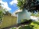 Side view of light blue house with wooden fence at 11335 Grandville Dr, Temple Terrace, FL 33617