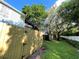 Backyard with wooden fence and grassy area at 11335 Grandville Dr, Temple Terrace, FL 33617