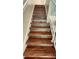Clean, modern staircase with wood-look laminate treads at 11335 Grandville Dr, Temple Terrace, FL 33617