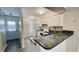 Modern kitchen features white cabinets, granite countertops, and stainless steel appliances at 11335 Grandville Dr, Temple Terrace, FL 33617