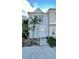 Light blue townhome with walkway and landscaping at 11335 Grandville Dr, Temple Terrace, FL 33617