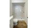 Clean bathroom with a marble-look shower and new flooring at 11335 Grandville Dr, Temple Terrace, FL 33617