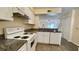 Bright kitchen boasts granite countertops and white cabinetry at 11335 Grandville Dr, Temple Terrace, FL 33617