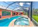 Inviting pool with a spa, screened enclosure, and surrounding patio at 2307 7Th Sw St, Ruskin, FL 33570