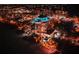 Nighttime aerial view of beachfront highrise building with pool and surrounding city lights at 4950 Gulf Blvd # 104, St Pete Beach, FL 33706