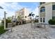 Outdoor grilling area with tables and chairs for dining al fresco at 4950 Gulf Blvd # 104, St Pete Beach, FL 33706