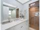 Bathroom with walk-in shower, modern vanity, and elegant decor at 4950 Gulf Blvd # 104, St Pete Beach, FL 33706