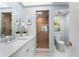 Updated bathroom with a walk-in shower, double vanity, and toilet at 4950 Gulf Blvd # 104, St Pete Beach, FL 33706