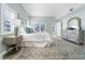 Main bedroom with water view and plush bedding at 4950 Gulf Blvd # 104, St Pete Beach, FL 33706