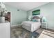 Bright bedroom with a queen-size bed and large artwork at 4950 Gulf Blvd # 104, St Pete Beach, FL 33706