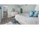 Guest bedroom with dresser, comfortable bed, and ensuite bathroom at 4950 Gulf Blvd # 104, St Pete Beach, FL 33706