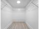 Large walk-in closet with wire shelving and light wood flooring at 4950 Gulf Blvd # 104, St Pete Beach, FL 33706