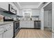 Updated kitchen, stainless steel appliances, white cabinets, and light flooring at 4950 Gulf Blvd # 104, St Pete Beach, FL 33706