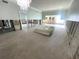 Spacious living room with light blue walls, chandelier, and doorway leading to another room at 4950 Gulf Blvd # 104, St Pete Beach, FL 33706