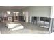 Bright and airy living room area with a chandelier and doorway leading to other rooms at 4950 Gulf Blvd # 104, St Pete Beach, FL 33706