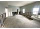 Empty living room with bare walls, windows, and doorways, offering a blank canvas for customization at 4950 Gulf Blvd # 104, St Pete Beach, FL 33706