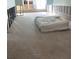Renovated living room with bare walls, exposed studs, and covered items, waiting for personalized touches at 4950 Gulf Blvd # 104, St Pete Beach, FL 33706