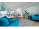 Bright living room with teal armchairs and a large comfy sofa at 4950 Gulf Blvd # 104, St Pete Beach, FL 33706
