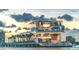 Contemporary waterfront pier building with sunset in the background at 4950 Gulf Blvd # 104, St Pete Beach, FL 33706