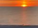 Stunning sunset over the ocean with beach in foreground at 4950 Gulf Blvd # 104, St Pete Beach, FL 33706