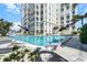 Inviting resort-style pool with lounge chairs and close proximity to building at 4950 Gulf Blvd # 104, St Pete Beach, FL 33706