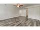 This spacious bedroom features modern wood floors, a ceiling fan, and a full ensuite bathroom at 911 8Th Sw Ave, Largo, FL 33770