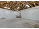 Spacious two-car garage featuring an open rafter ceiling, utility sink, and door leading to the interior of the house at 911 8Th Sw Ave, Largo, FL 33770