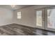 Bright living room boasts wood-look floors, neutral walls, and backyard access through glass doors at 911 8Th Sw Ave, Largo, FL 33770