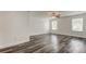 The main bedroom has wood-look floors, a ceiling fan, and two windows for plenty of natural light at 911 8Th Sw Ave, Largo, FL 33770