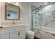 Clean bathroom with white vanity, gray floor, and a shower/tub combo at 911 8Th Sw Ave, Largo, FL 33770