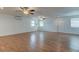 Open living area with hardwood floors, ceiling fans, and multiple windows at 911 8Th Sw Ave, Largo, FL 33770