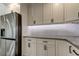 Stainless steel refrigerator and white cabinets with granite countertops at 911 8Th Sw Ave, Largo, FL 33770