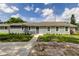 Newly built home with gray siding, stone accents and a landscaped yard at 911 8Th Sw Ave, Largo, FL 33770