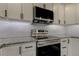 Stainless steel appliances and white cabinets in a modern kitchen at 911 8Th Sw Ave, Largo, FL 33770