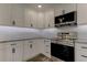 Modern kitchen with white cabinets, granite countertops, and stainless steel appliances at 911 8Th Sw Ave, Largo, FL 33770