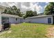 Private backyard with a stone path separating two structures at 911 8Th Sw Ave, Largo, FL 33770