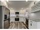 Modern kitchen with white shaker cabinets, granite countertops, and stainless steel appliances at 911 8Th Sw Ave, Largo, FL 33770