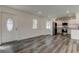 Open living area with hardwood floors, white walls, and kitchen access at 911 8Th Sw Ave, Largo, FL 33770