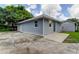 Newly built home with gray siding and a detached garage at 911 8Th Sw Ave, Largo, FL 33770