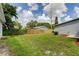 Large backyard with a wooden fence and stone path at 911 8Th Sw Ave, Largo, FL 33770