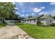 Charming single-story home with gray siding and landscaping at 911 8Th Sw Ave, Largo, FL 33770