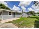 Newly built home with gray siding and a detached garage at 911 8Th Sw Ave, Largo, FL 33770