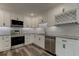 Modern kitchen with white cabinets, granite countertops, and stainless steel appliances at 911 8Th Sw Ave, Largo, FL 33770