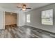 Bedroom with two windows, ceiling fan, and gray vinyl flooring at 911 8Th Sw Ave, Largo, FL 33770
