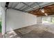 Spacious garage with overhead door and wooden beams at 911 8Th Sw Ave, Largo, FL 33770