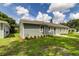 Newly constructed home with gray siding, landscaping, and a spacious yard at 911 8Th Sw Ave, Largo, FL 33770