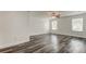 Bright bedroom with ceiling fan and grey wood-look flooring at 911 8Th Sw Ave, Largo, FL 33770