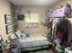 Cozy bedroom featuring a bed, window, and clothing rack at 1874 Douglas Ave, Clearwater, FL 33755