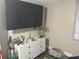 Bedroom with large TV and dresser at 1874 Douglas Ave, Clearwater, FL 33755