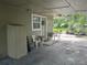 Small back patio with seating and storage shed at 1874 Douglas Ave, Clearwater, FL 33755